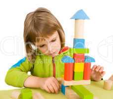 child plays with toy blocks