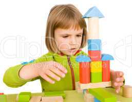 child plays with toy blocks