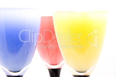 glasses with different colored drinks isolated on white