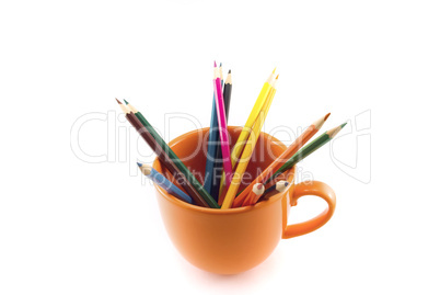 mug with colored pencils isolated on white