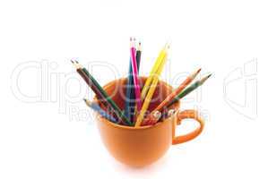 mug with colored pencils isolated on white
