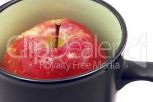 apple in a cup isolated on white