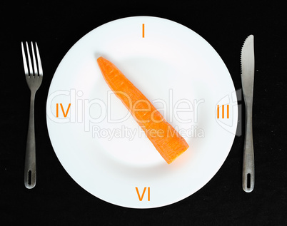 Carrot in a white plate on black background