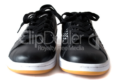 Black trainers with a yellow sole