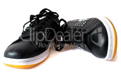 Black trainers with a yellow sole