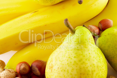 bananas, pears and nuts on white background