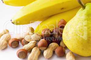 bananas, pears and nuts on white background