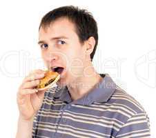 The young man is appetizing eats a hamburger