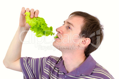 The young man is appetizing eats green salad