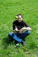 man sitting on green grass