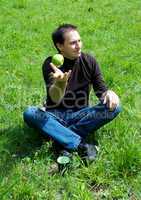 man sitting on green grass