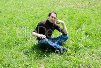 man sitting on green grass