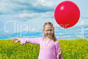 Girl with balloon in meadow