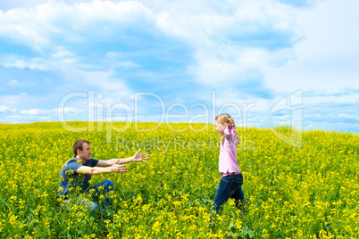 The father with a daughter on a meadow