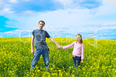 The father with a daughter on a meadow