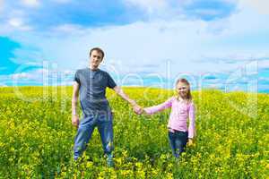 The father with a daughter on a meadow