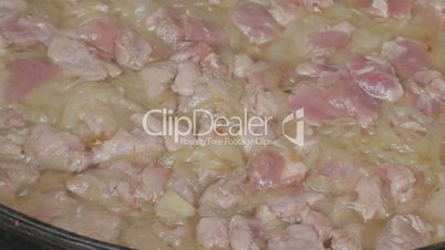Cut pork with sliced onions keeps languishing, close-up