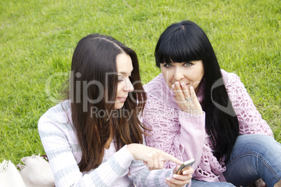 Mother and daughter with phone