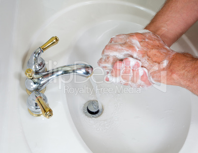 Senior male wash hands with soap