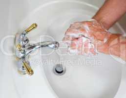 Senior male wash hands with soap