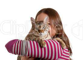 Bengal kitten on arm of young girl facing camera