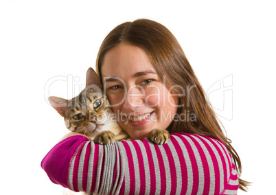 Bengal kitten on arm of young girl facing camera