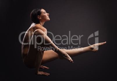 nude beauty woman in dark exercise yoga