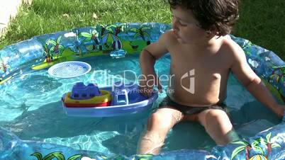 Little boy playing in wading pool
