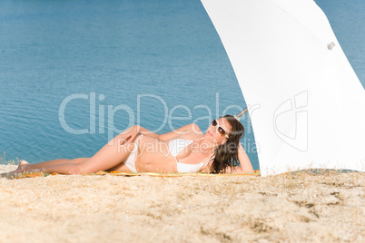 Young sexy bikini model relaxing with sunglasses