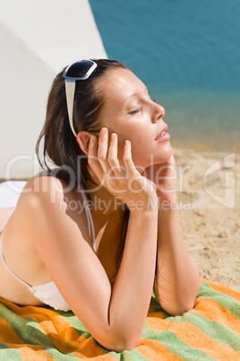 Summer beach young woman sunbathing in bikini