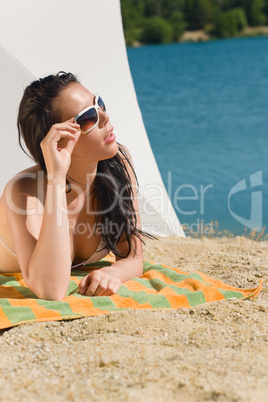 Summer beach young woman sunbathing in bikini