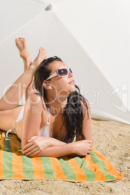 Summer beach young woman sunbathing in bikini