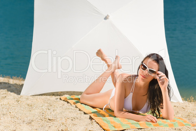 Summer beach young woman sunbathing in bikini