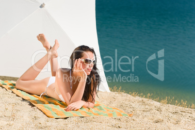 Summer beach young woman sunbathing in bikini