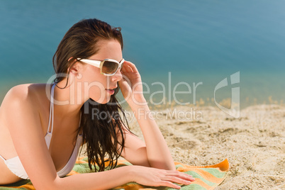 Summer beach young woman sunbathing in bikini