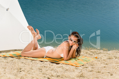 Summer beach young woman sunbathing in bikini