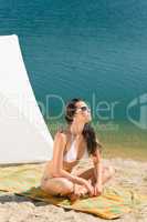 Summer beach young woman sunbathing in bikini