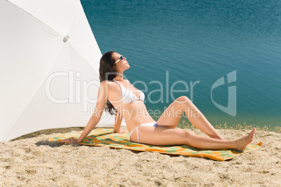 Summer beach young woman sunbathing in bikini