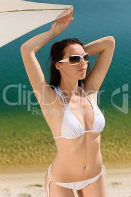 Summer beach woman posing in white bikini