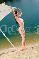 Summer beach woman posing in white bikini