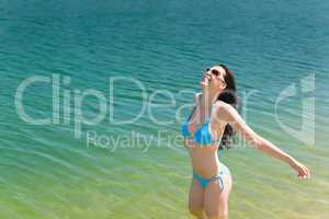 Summer beach woman in bikini swim water