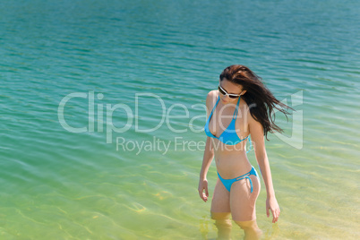 Summer beach woman in bikini swim water