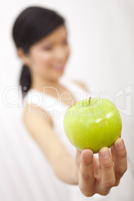 Asian Chinese Girl Holding Fresh Green Apple to Camera