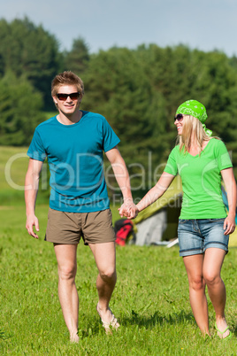 Young camping couple hold hands summer countryside