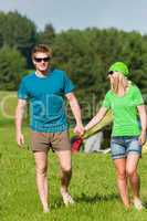 Young camping couple hold hands summer countryside