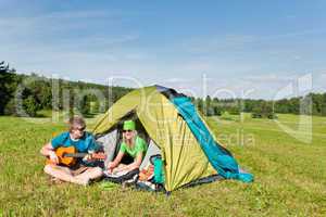 Camping couple play guitar summer in countryside
