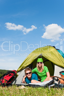 Camping couple lying inside tent summer countryside