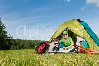 Camping couple lying inside tent summer countryside