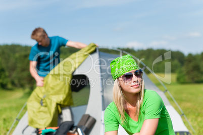 Camping couple build-up tent sunny countryside