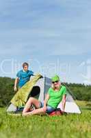 Camping couple build-up tent sunny countryside